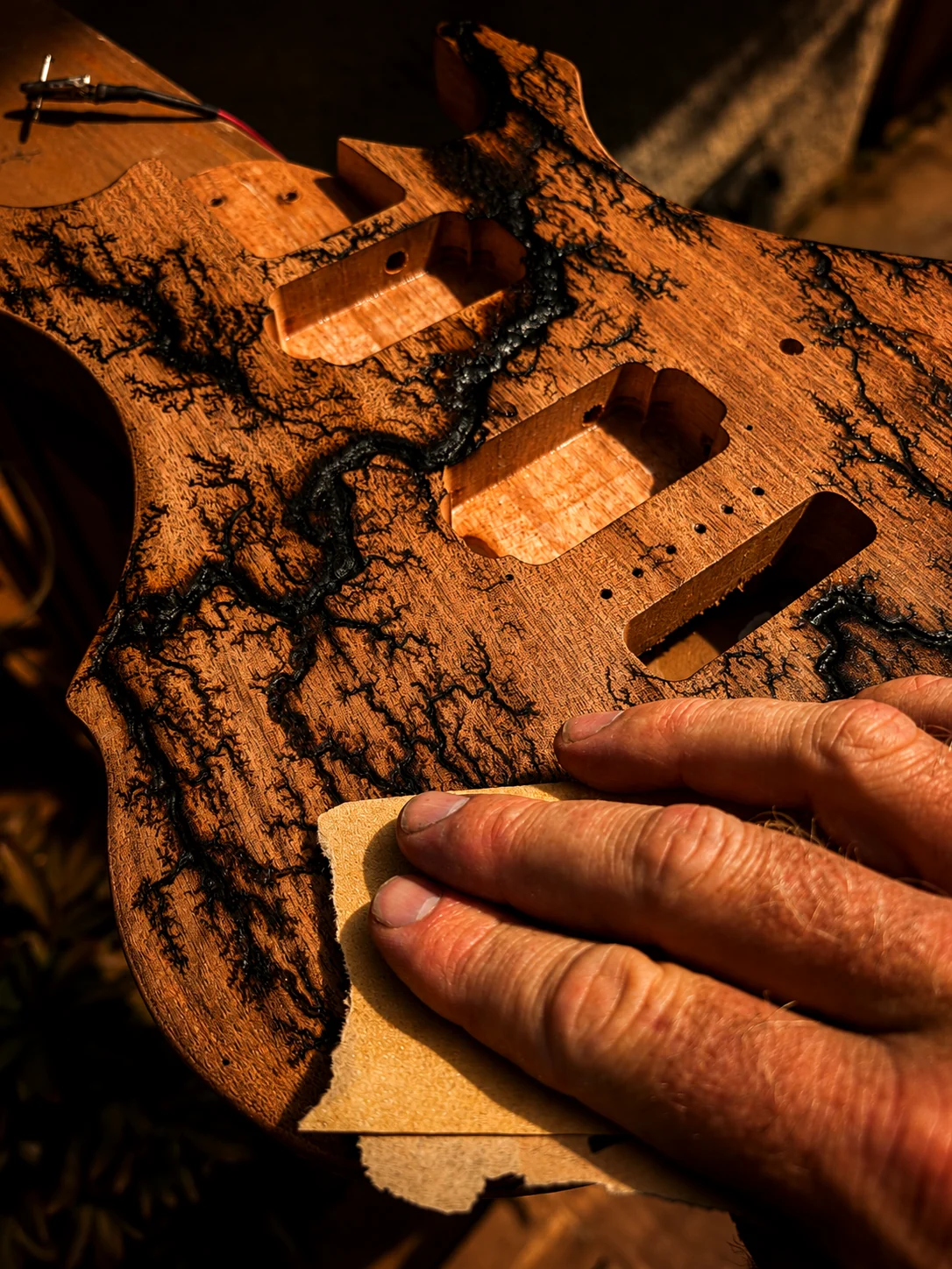 Hand sanding guitar body